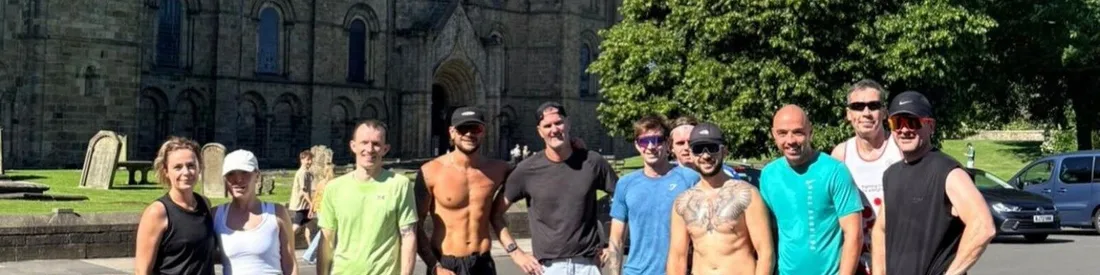 Durham Social Run Club lined up in the sunshine in front of Durham Cathedral