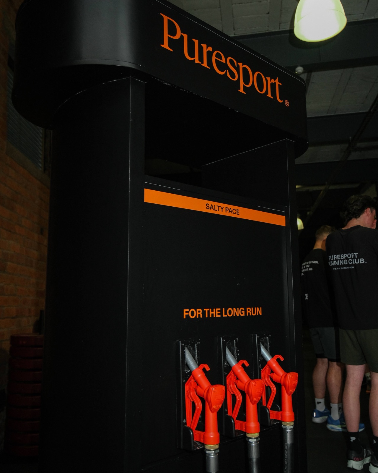 Puresport's black and orange fuelling station with hydration taps at the Newcastle venue