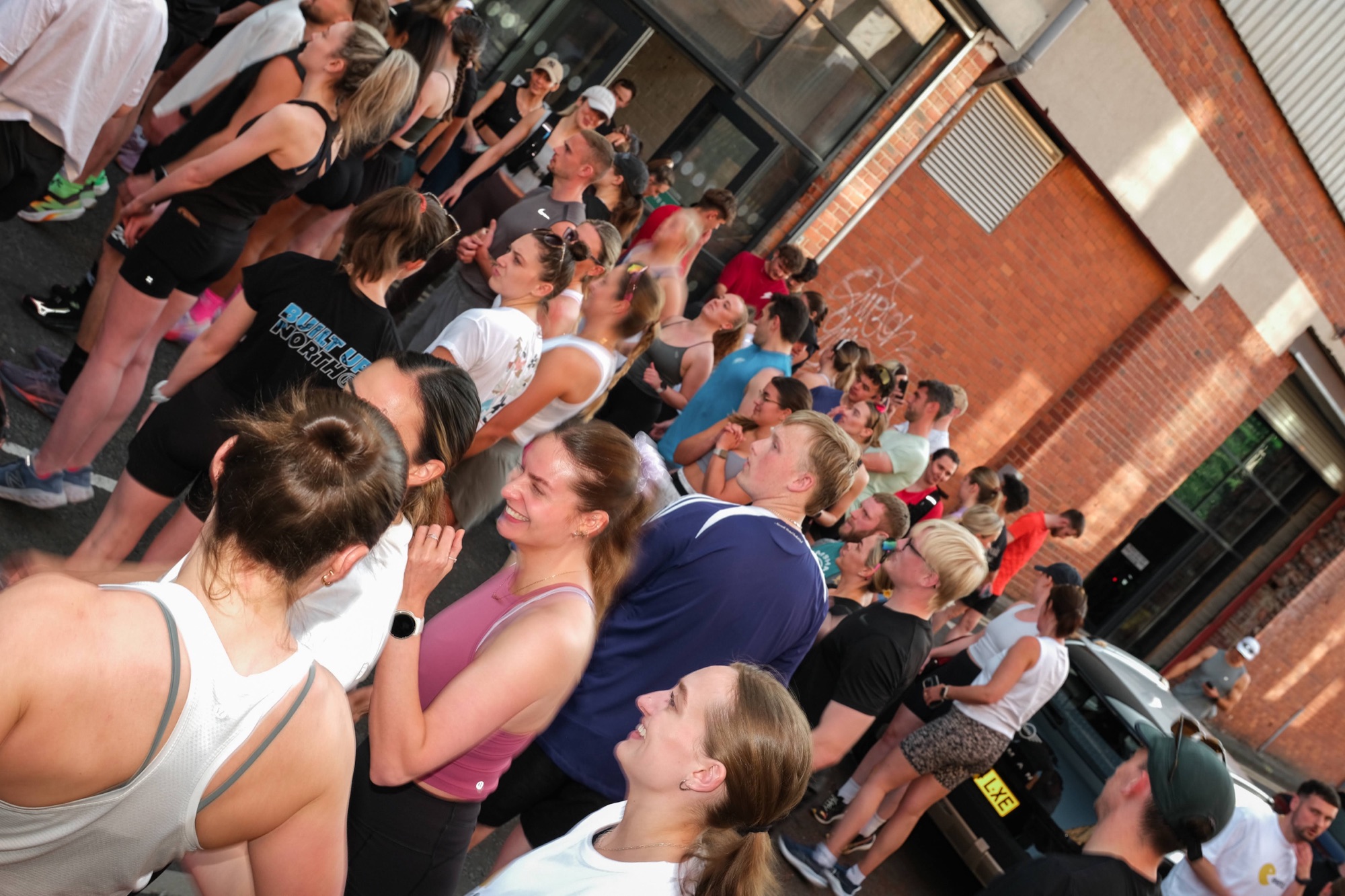 Runners chatting and laughing together before a Puresport session in Newcastle
